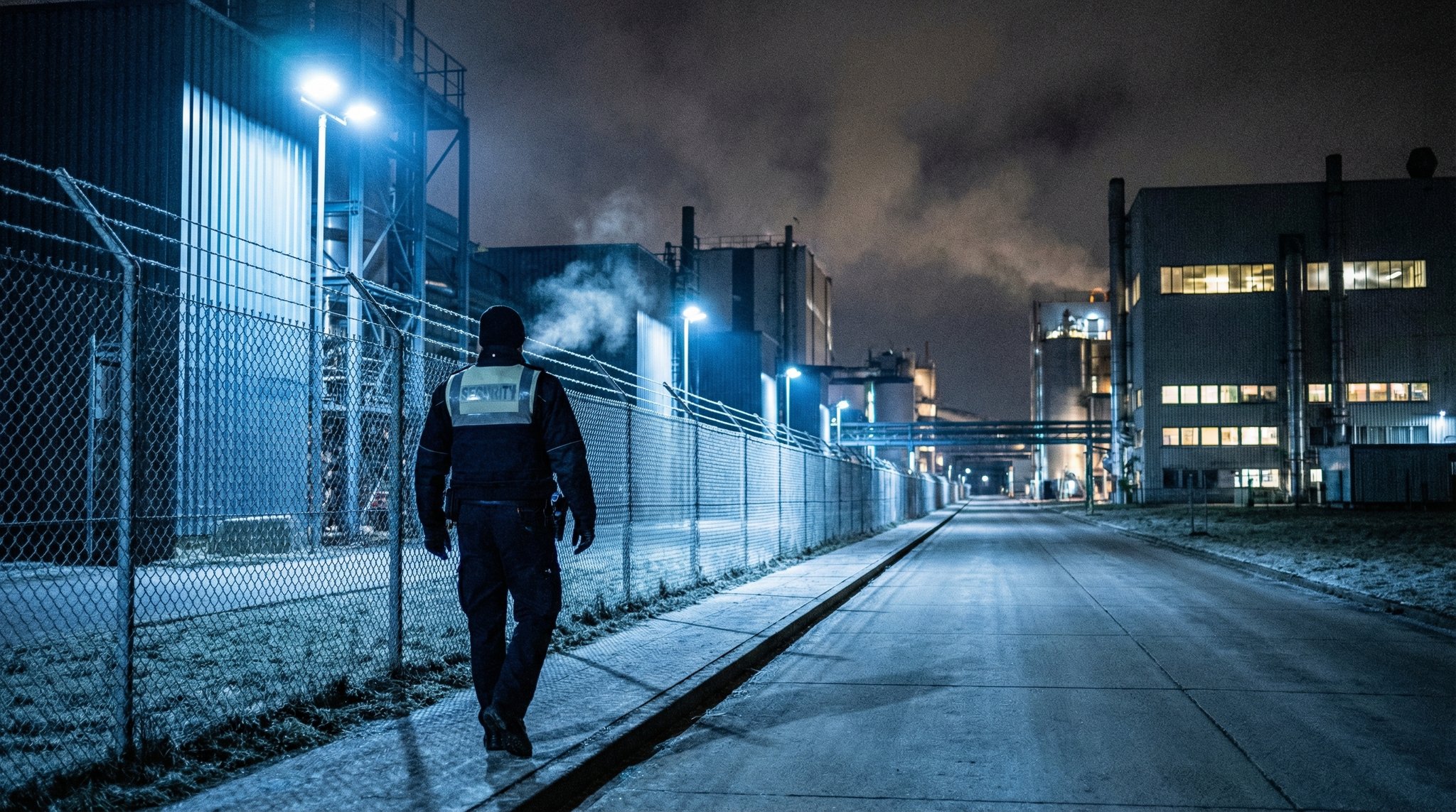 Sicherheitsmitarbeiter auf Nachtschicht an einem Industriegelände
