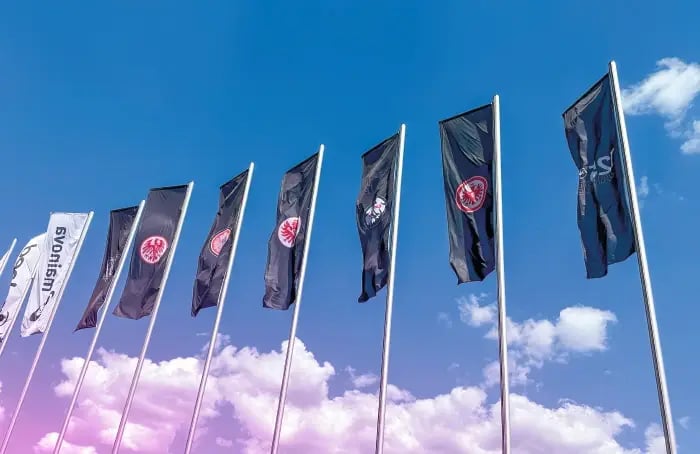 Waving flags in front of the Eintracht Frankfurt stadium
