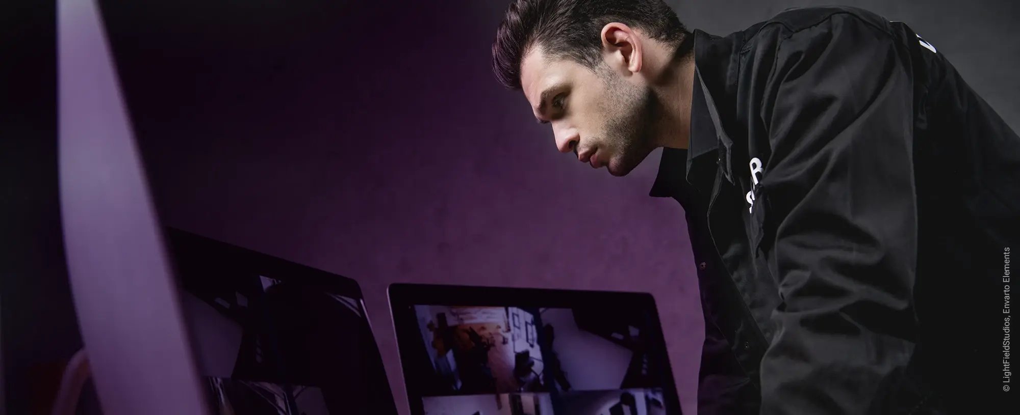 Guard looking at monitors during his security shift