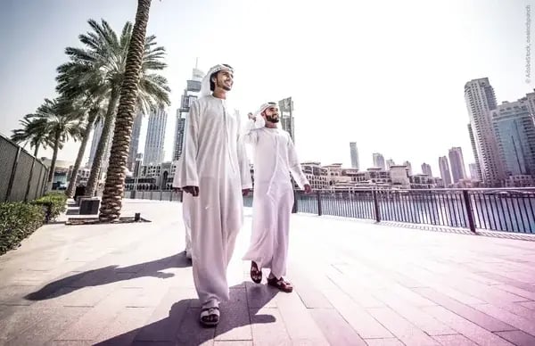 Modern cityscape in Saudi Arabia with men in traditional attire