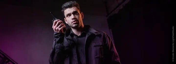 Guard in uniform uses walkie-talkie 