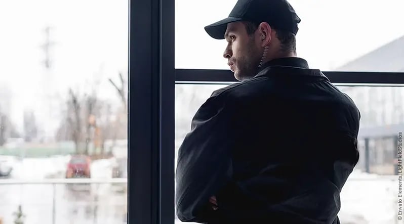 rear-view-of-guard-in-black-uniform-with-earphone-WE3QRTK_Envato_Elements_LightFieldStudios_800