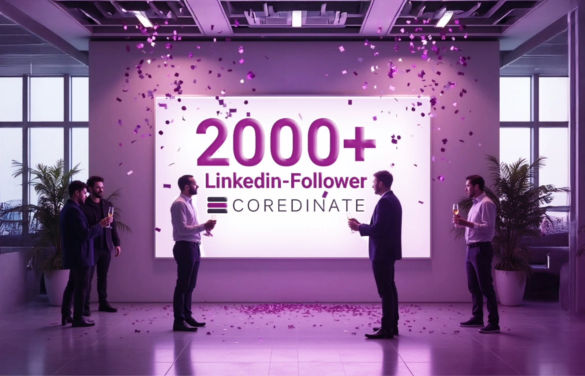 People stand in front of a large screen that announces the 2000 followers on COREDINATE-LinkedIn.